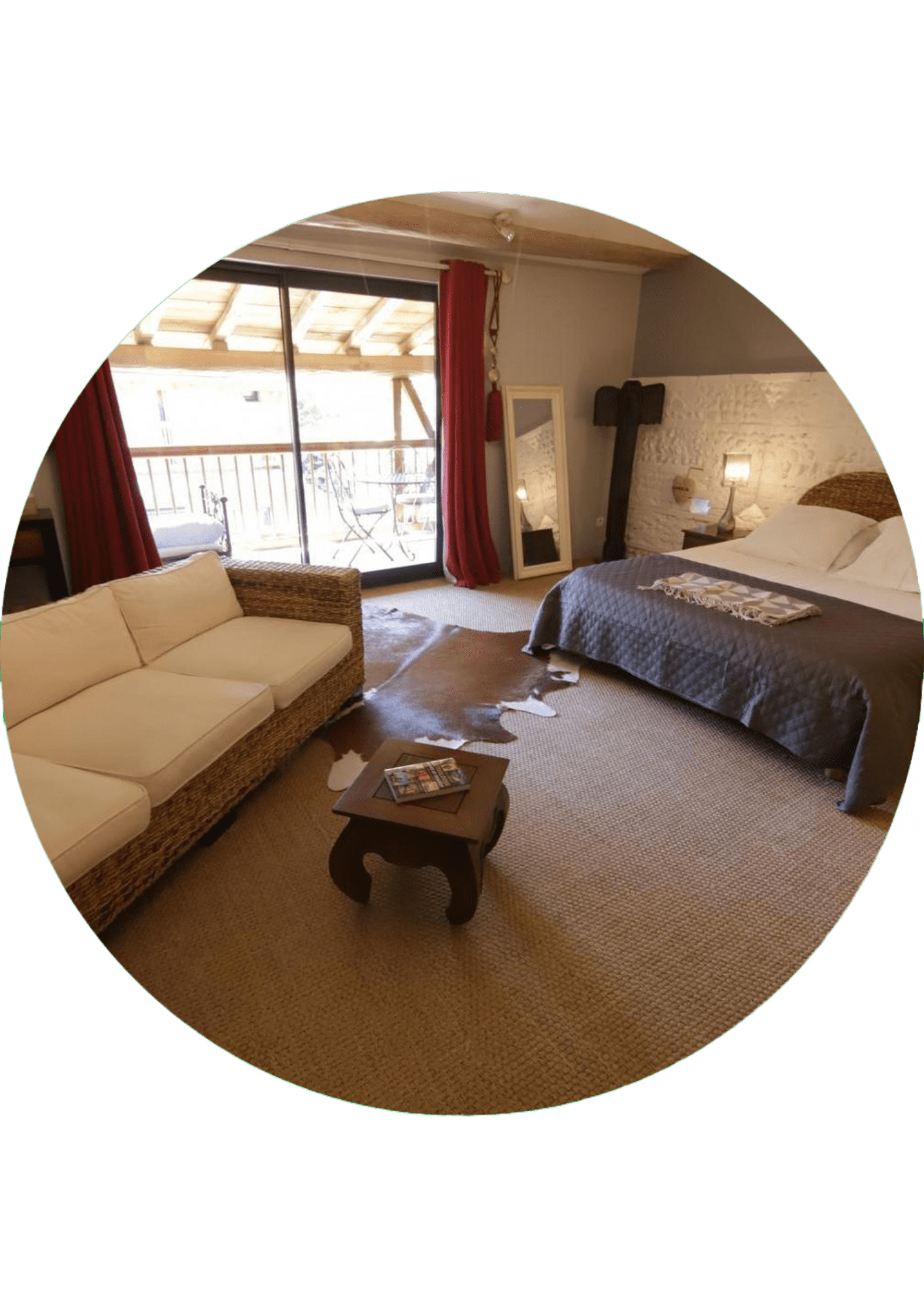 A cozy bedroom suite with a sofa, a double bed, a cowhide rug and a private balcony